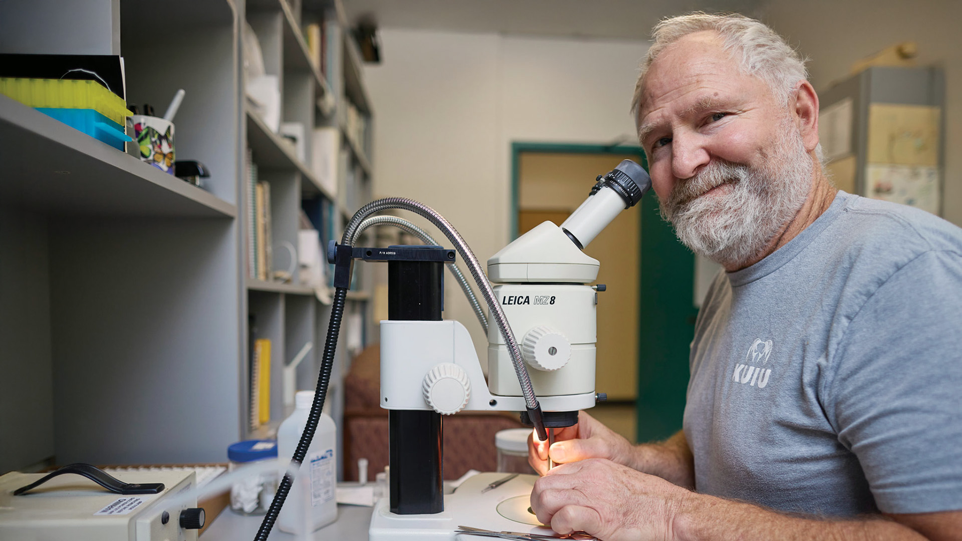 Closeup of Marshal Hedin sitting behind microscope.