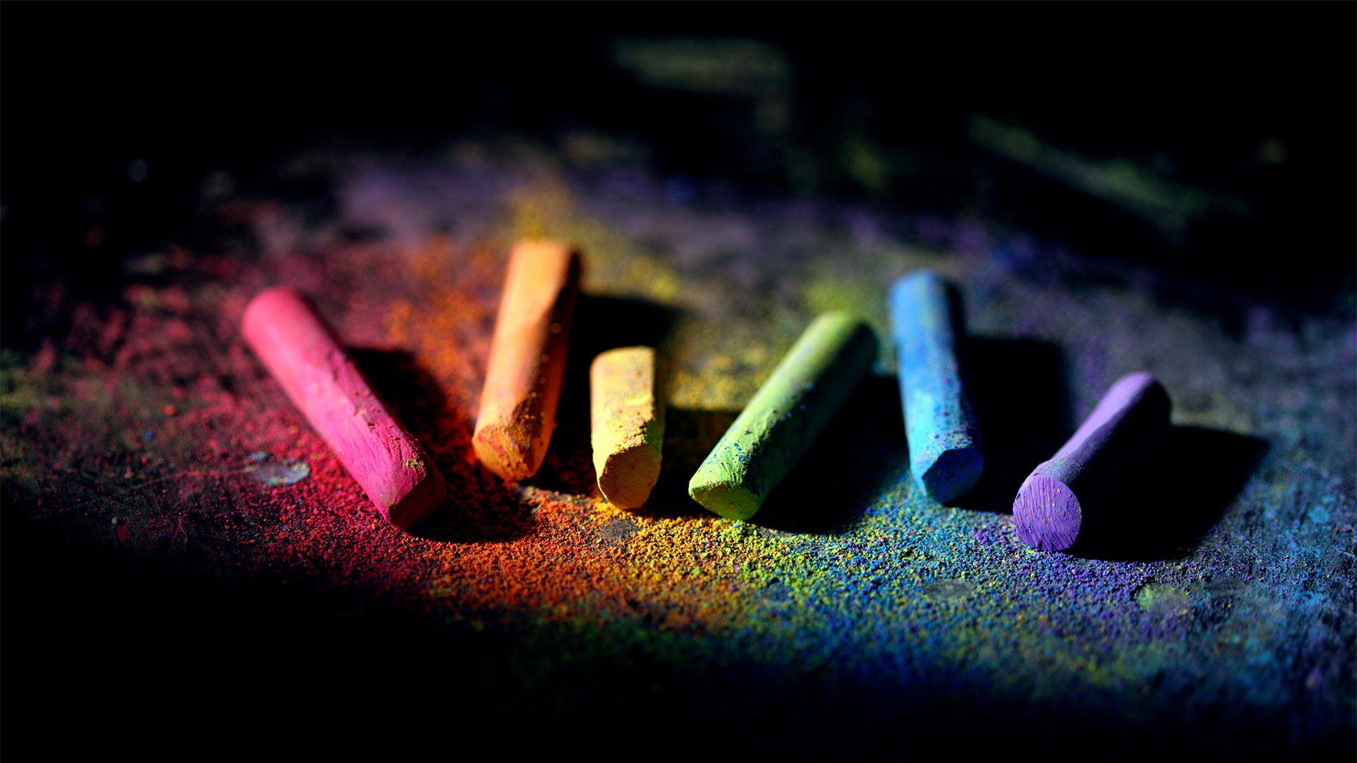 red, orange, yellow, green, blue, and violet chalk on black background.