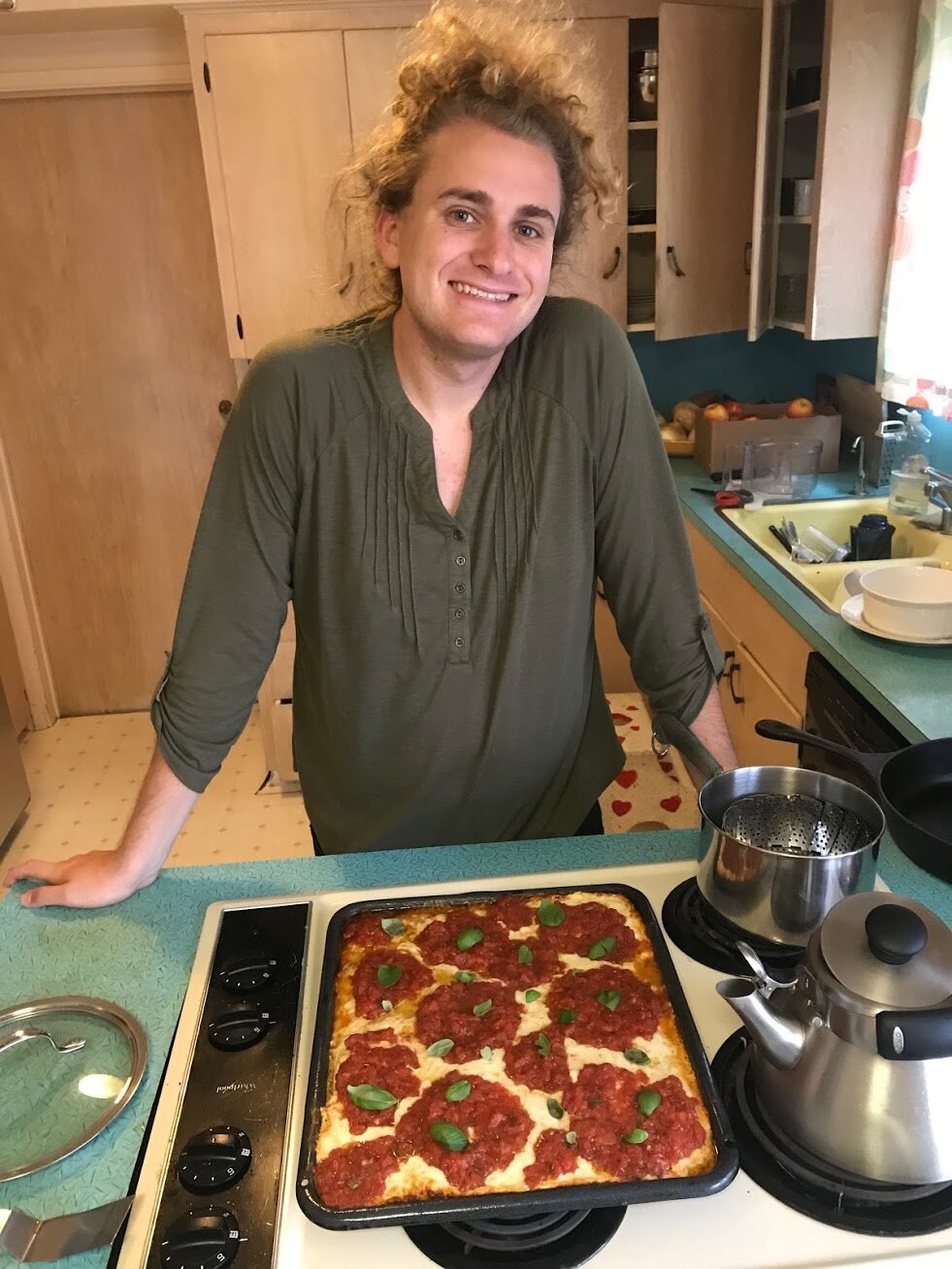 Brieen Hayes showing of pizza they baked.