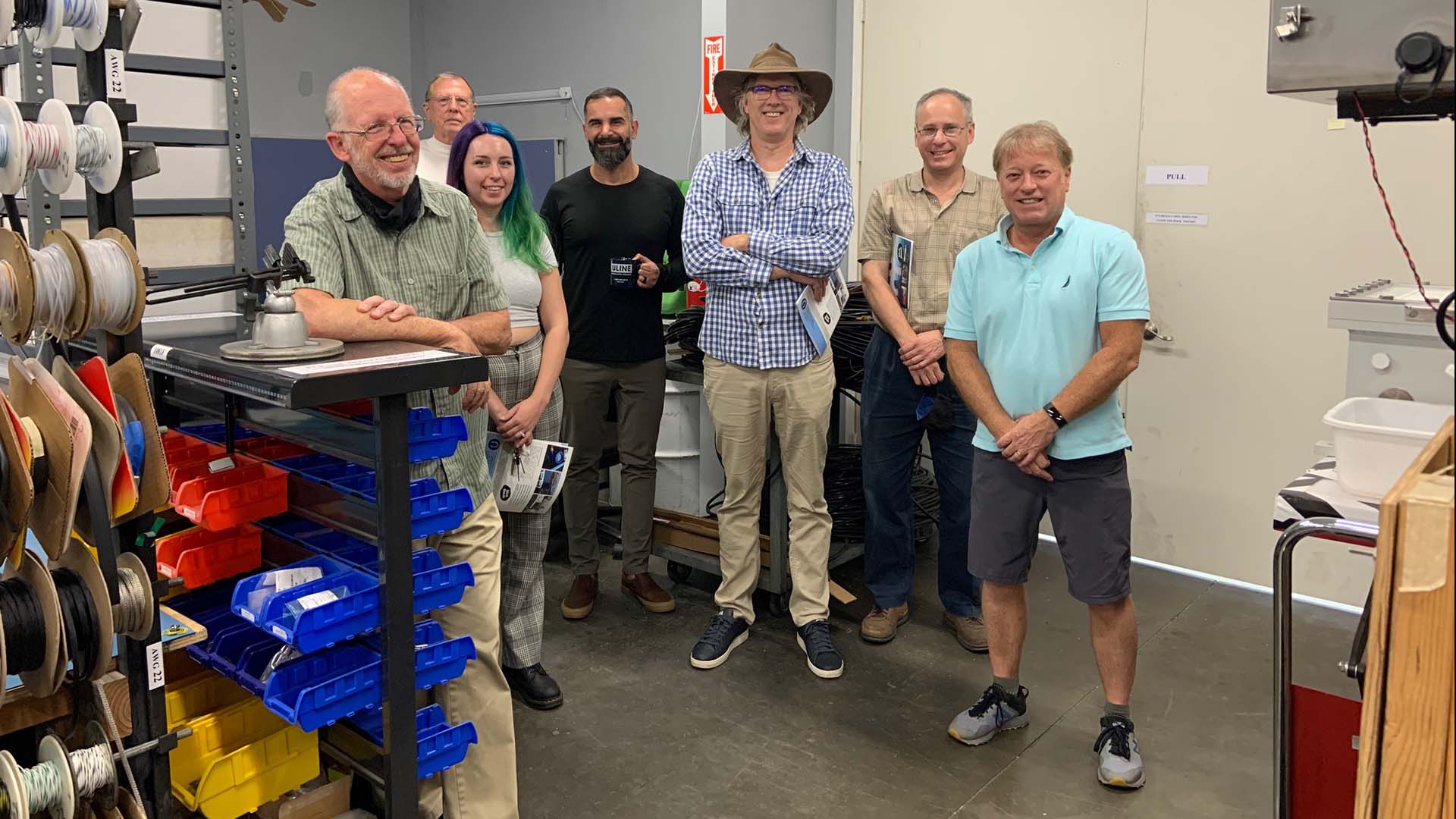 Multiple researchers stand shoulder to shoulder in lab