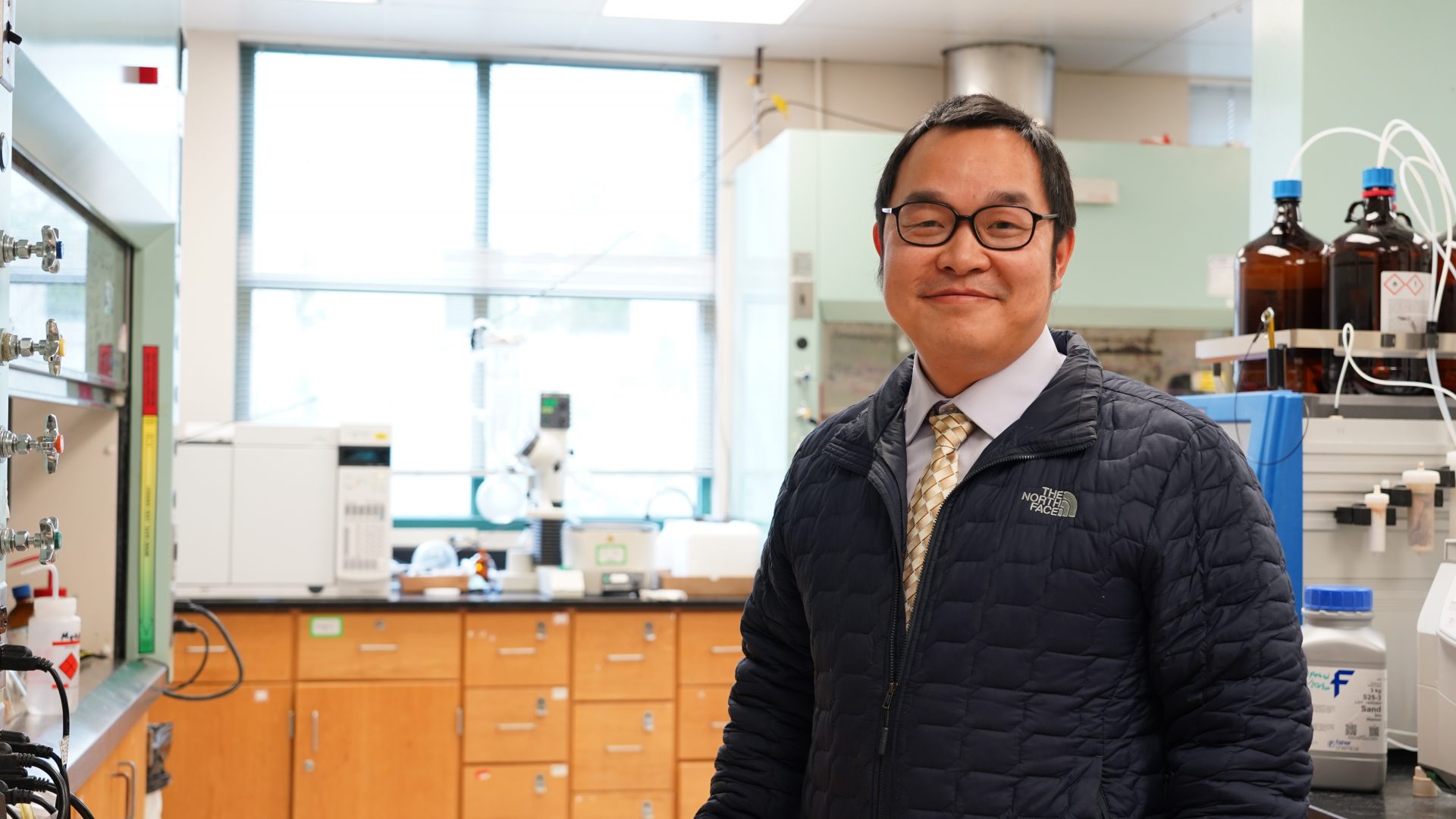 Yong Yan smiles in his brightly lit chemistry lab.