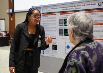 Student explains her research poster