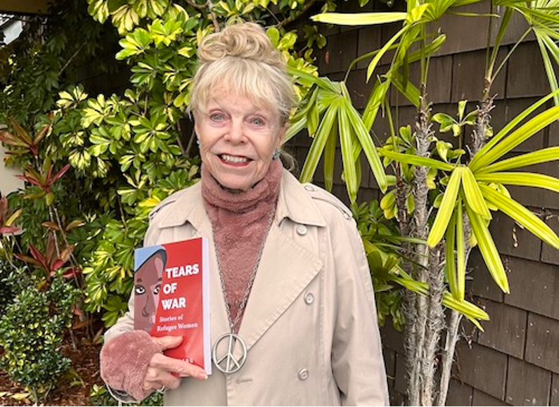 Hoiberg poses holding her book