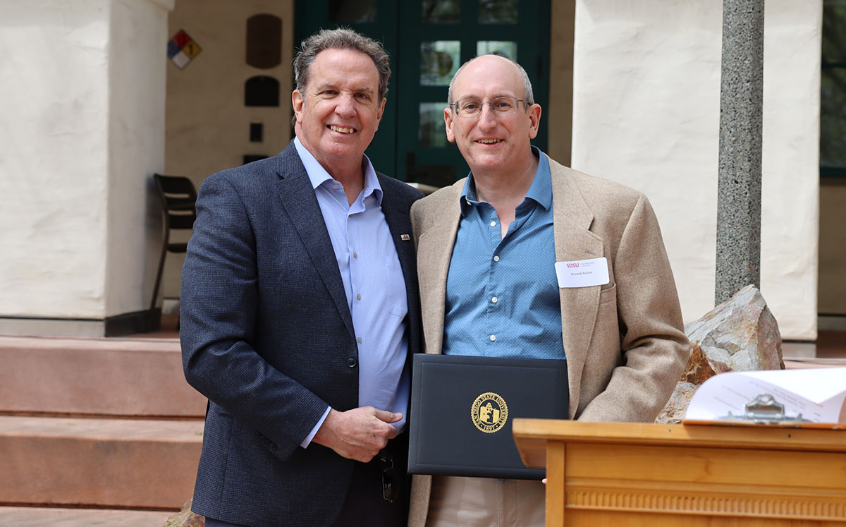 Tim Day shakes hands with Ken Nollett in Day quad.