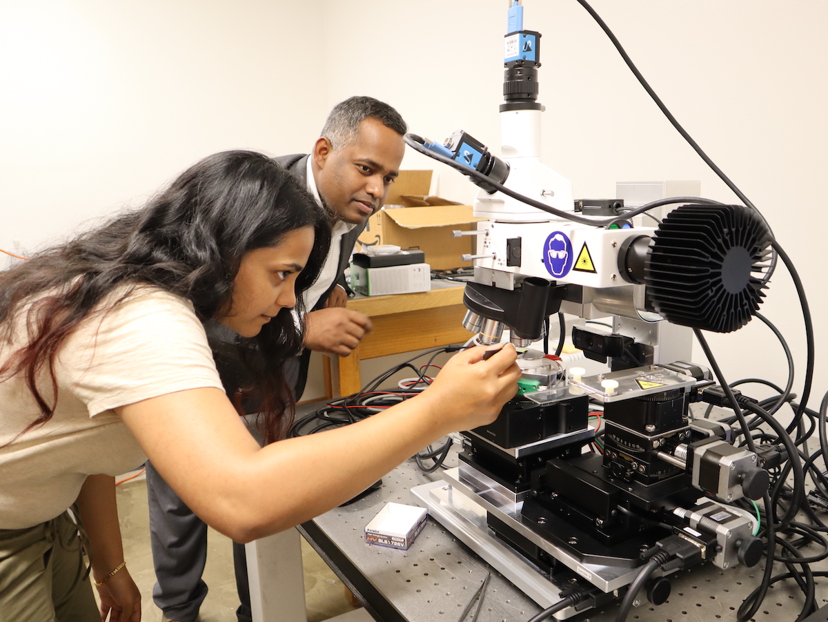 Physics professor Sanjay Behura looks on as second-year Physics master’s student Sancia Tauro investigates quantum defects in hexagonal boron nitride in the Quantum Materials Design and Growth Lab.