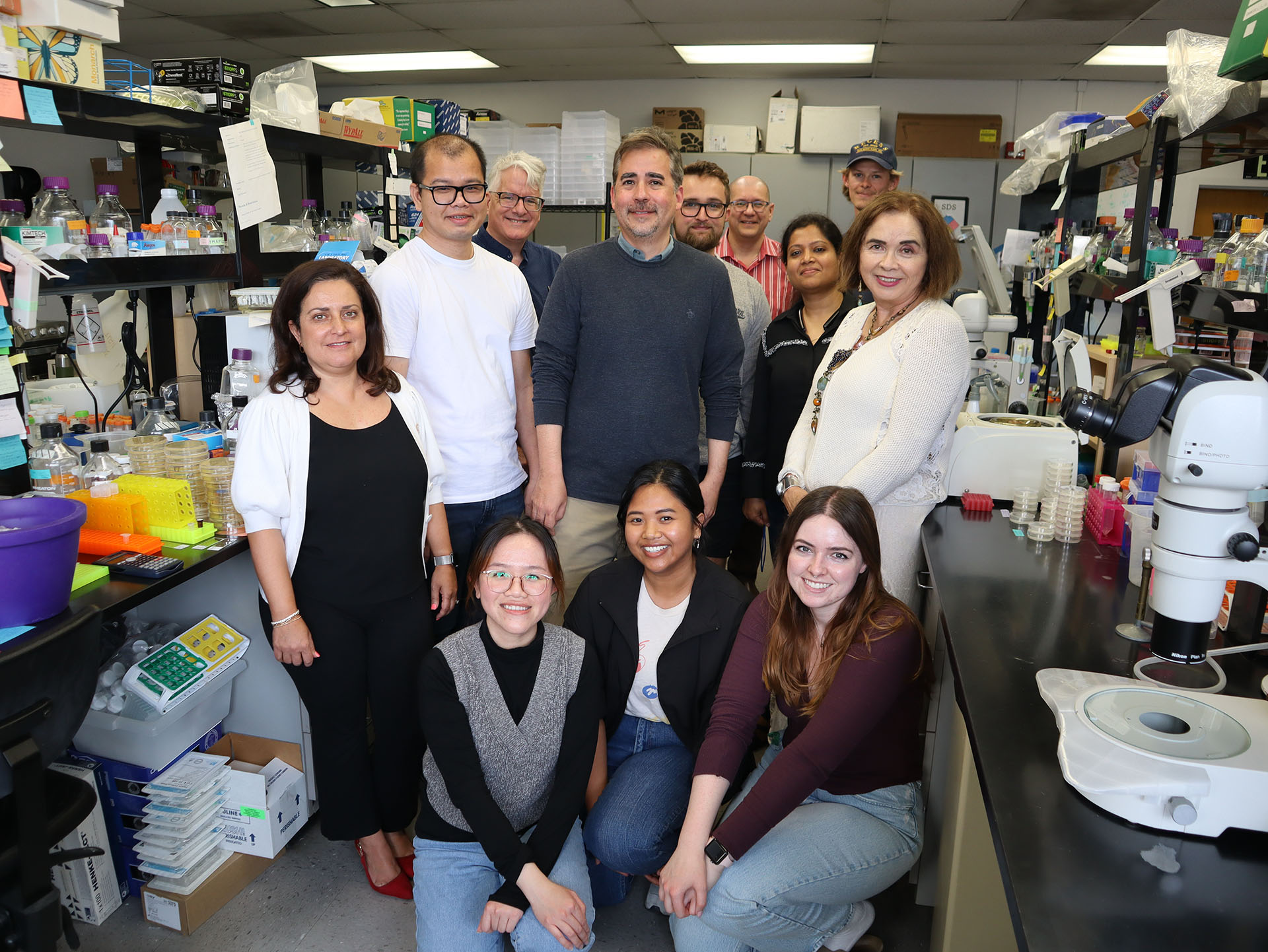 SDSU President Adela de la Torre visits Assistant Professor Robert Luallen's lab<br />
12 poeple posing in lab.</p>
<p>